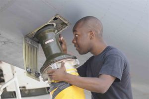 Indoor air quality duct cleaning man holding vacuum
