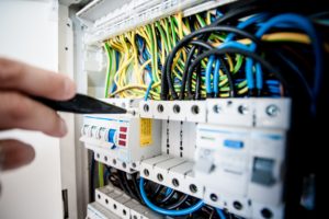 Home Maintenance Jobs best left to the professionals electrician tests the wiring