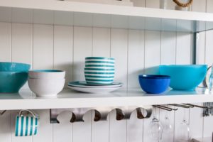 Family-friendly kitchen bright colored dishes on shelf