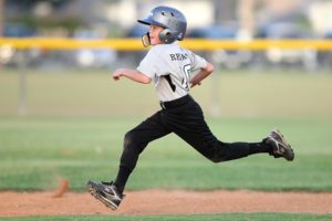 Child's sporting activities - boy running in softball