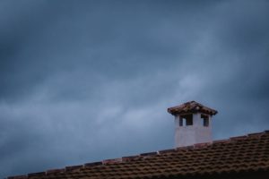 Home in a spring clean chimney on a roof at night