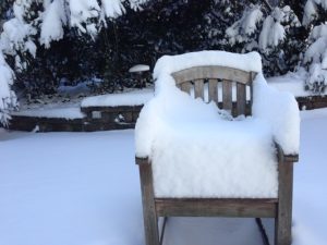 Keep your backyard safe snow covered chair in backyard