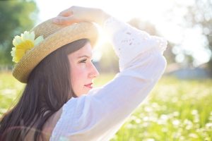 Warmer Weather woman wearing sun hat in summer