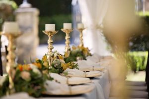Flower wedding decor head table flower decorations between brass candlesticks