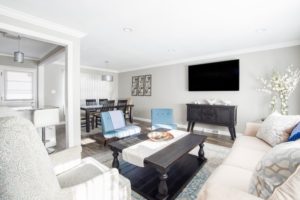 Aesthetic appearance of your home living room decor example light gray walls artificial plant white blue chairs white coffee table runner