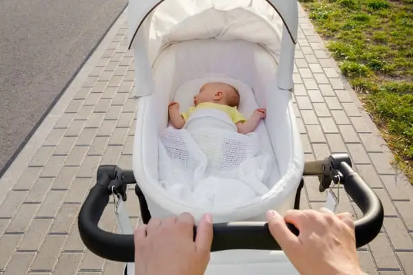 mother pushing jogging stroller