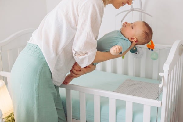 setting baby down into crib