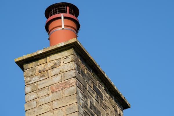 detailed-view-of-an-english-cottage-chimney-and-birds-next-preventer