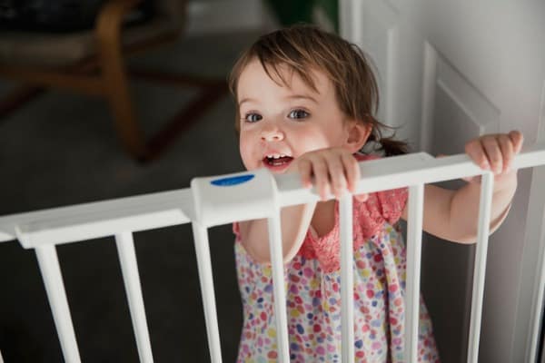 little girl at safety-gate