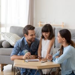 caring-mom-and-dad-teaching-little-daughter