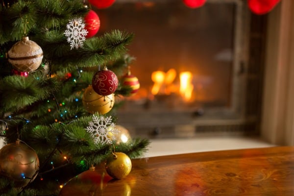 closeup-image-of-golden-baubles-on-christmas-tree-at-fireplace