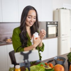 smiling young lady looking at her vitamins