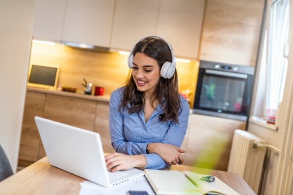 young beautiful businesswoman listening music in headphones