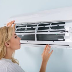 young-woman-checking-air-conditioner