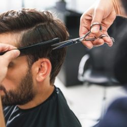 barber using scissors and comb