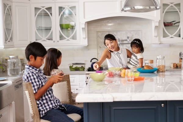busy mother organizing children at breakfast in kitchen picture id538044936