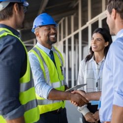 engineer and businessman handshake at construction site