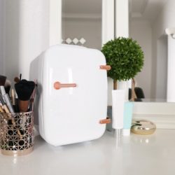 mini fridge for cosmetic products on white vanity table picture