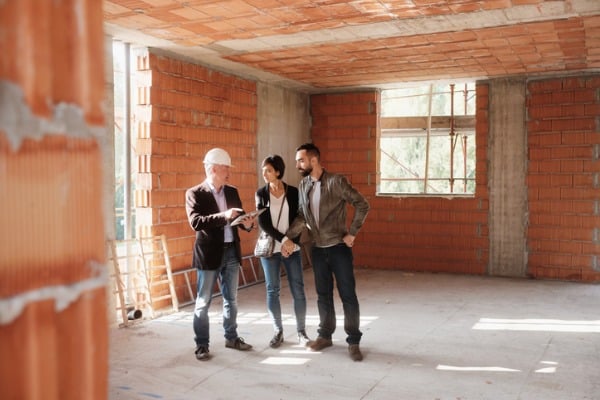 realtor showing new home to happy married couple