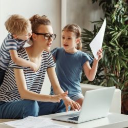 stressed woman with kids working from home