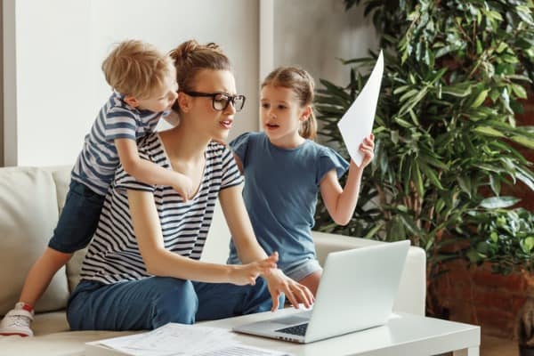 stressed woman with kids working from home