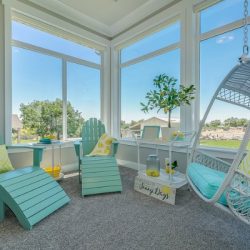 sunroom with turquoise and yellow colors with a hanging chair