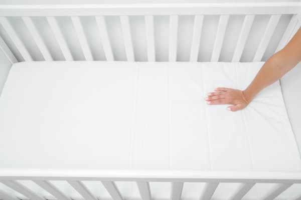 woman hand pressing on white mattress mother checking hardness
