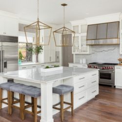 beautiful kitchen in new luxury home with island pendant lights