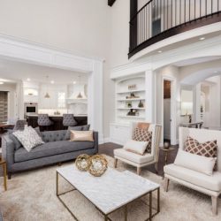 beautiful living room interior with tall vaulted ceiling loft area