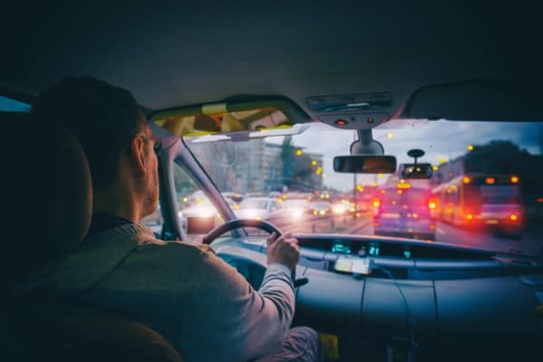 driving a car in the city at night in traffic jams