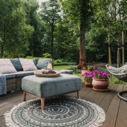 garden patio decorated with scandinavian wicker sofa and coffee table