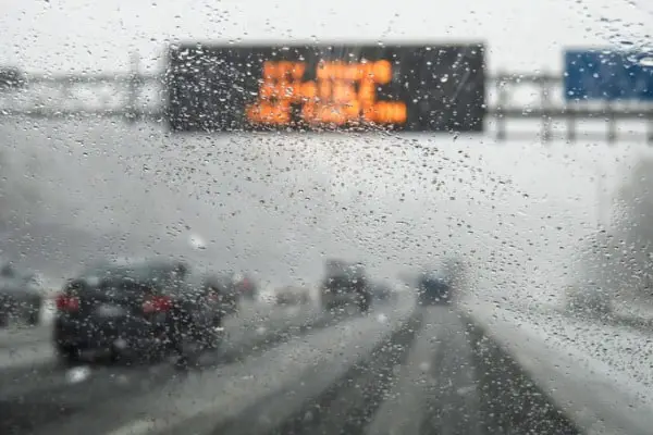hazardous weather condition on the road seen through windshield