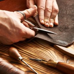 man working with leather