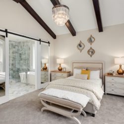 master bedroom in new luxury home with chandelier