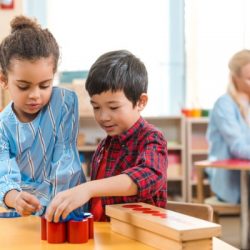 selective focus of kids folding educational game with teacher