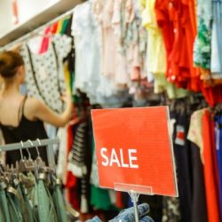 woman looking clothes on discount in the shopping mall seasonal sale
