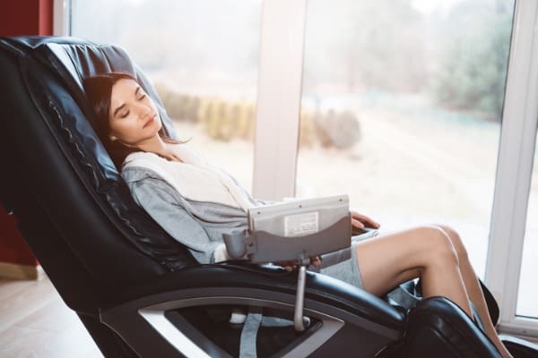 young woman relaxing on the massaging chair