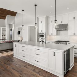 beautiful kitchen in new luxury home with island pendant lights