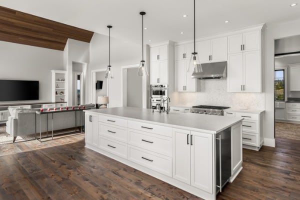 beautiful kitchen in new luxury home with island pendant lights