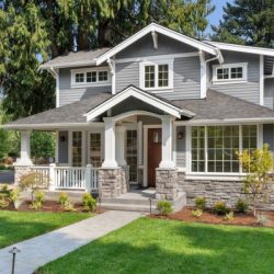 beautiful luxury home exterior on bright sunny day with green grass