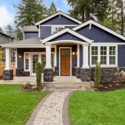 beautiful luxury home exterior with green grass and landscaped yard