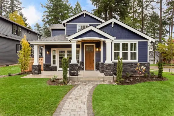 beautiful luxury home exterior with green grass and landscaped yard