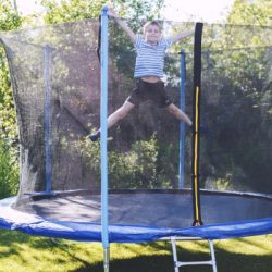 boy jumping on trampoline the child plays on a trampoline outdoor