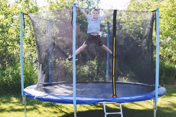 boy jumping on trampoline the child plays on a trampoline outdoor