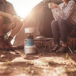 couple sitting in chairs outside the tent