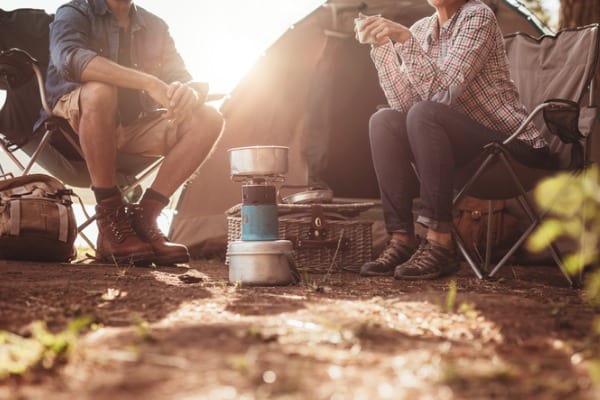 couple sitting in chairs outside the tent