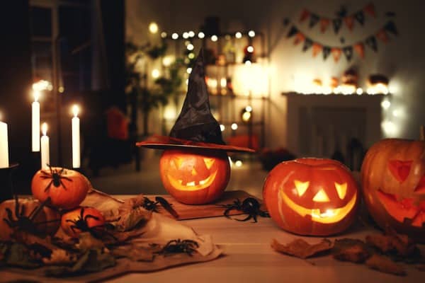 dark interior of house decorated for halloween pumpkins webs