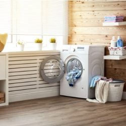 interior of real laundry room with washing machine at window at home