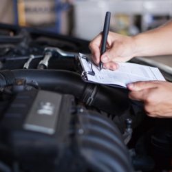 mechanic repairman inspecting car