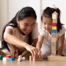 overjoyed vietnamese mother little daughter play at home